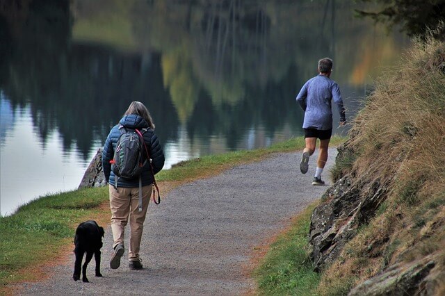 Man trail running on a path.