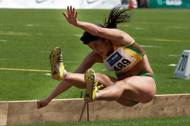 Long jumper going through action in air